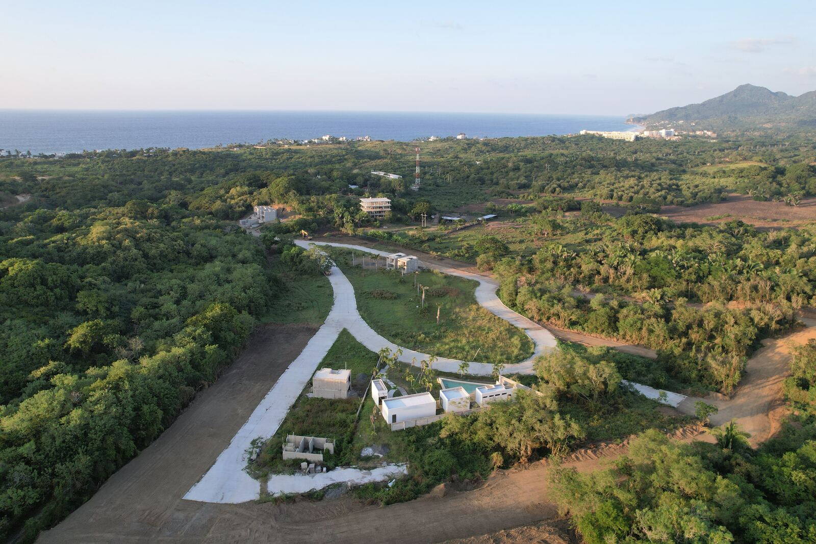 Drone photo of Cumbres de Mita, with its roads through the jungle and the Punta de Mita coastline behind